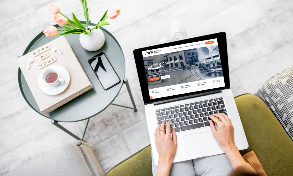 Own My Website - Laptop with Bespoke Website Next to Coffee Table - Web Design and SEO Company Limited